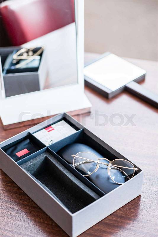 New glasses in present box at optician store, stock photo
