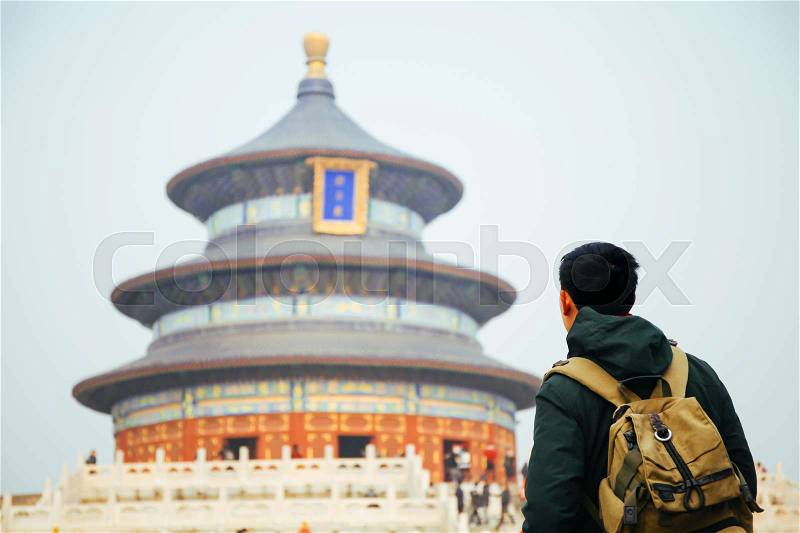 Young traveler standing in front of temple of heaven - in Beijing, China. Asia Travel, stock photo
