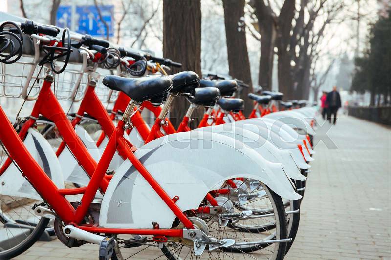 Public Bike Rental Station in Beijing, China with Bicycles arranging in row ready for public rental, stock photo