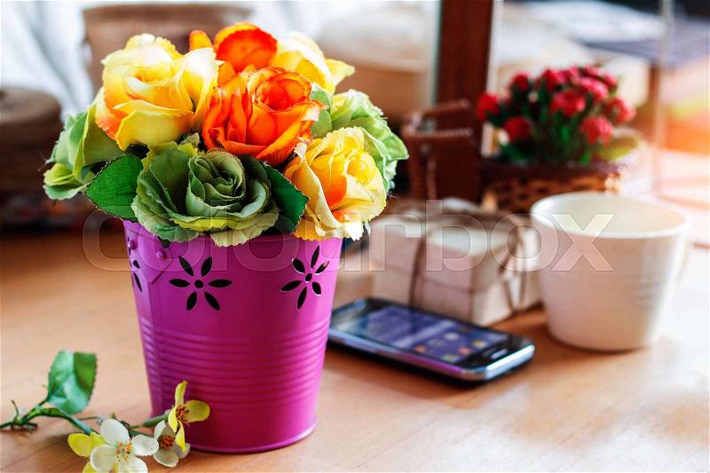 Colorful roses in a vase on the desk, stock photo