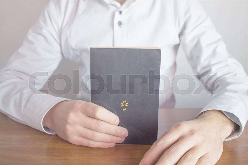 Bible on businessman hand, stock photo