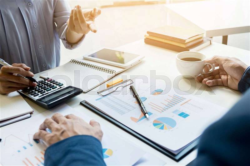 Business man financial inspector and secretary making report, calculating or checking balance. Internal Revenue Service inspector checking document. Audit concept, stock photo