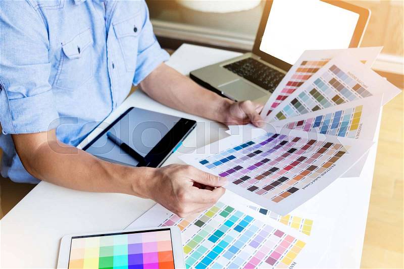 Interior design or graphic designer renovation and technology concept - woman working with color samples for selection, stock photo