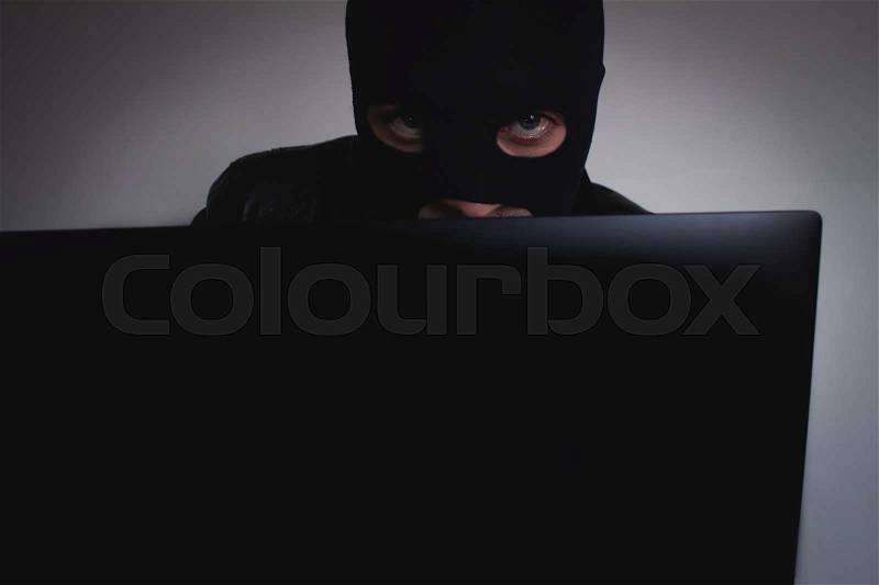 Hacker with computer, stock photo