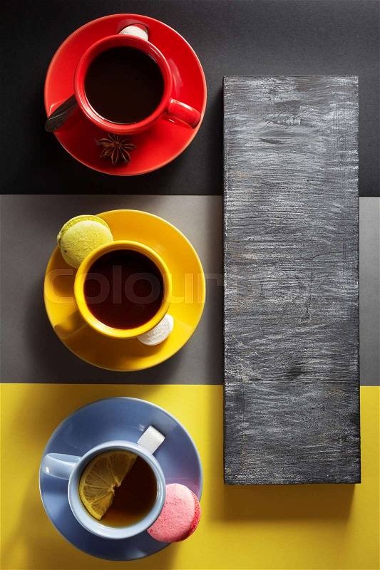 Cup of coffee, cacao and tea at colorful paper background, stock photo