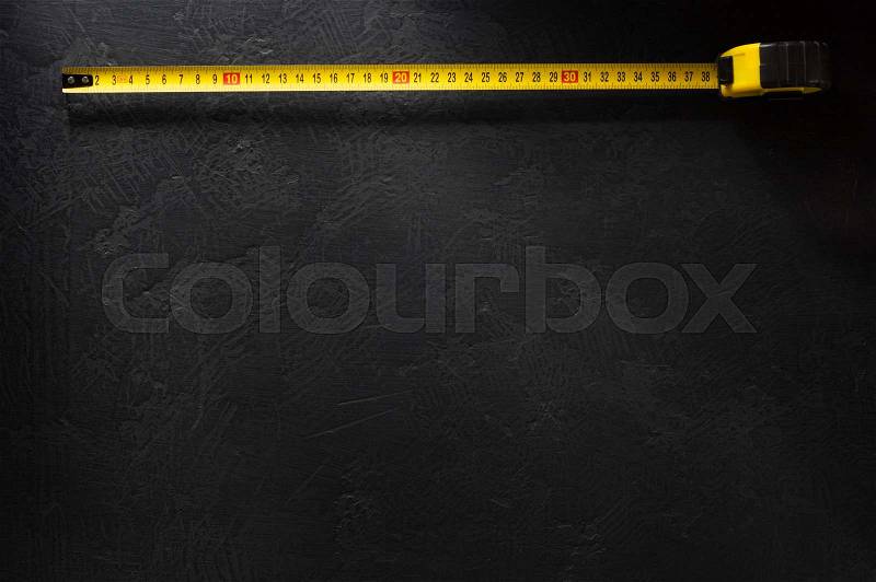Tape measure on black backgraund, stock photo