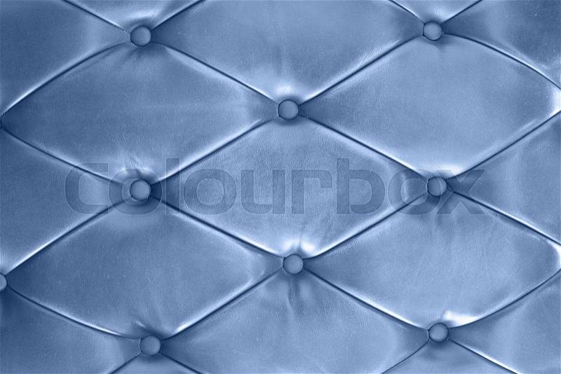 Classic blue leather texture of a couch with leather buttons, stock photo