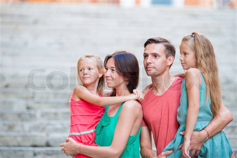 Family of four on european vacation. Airplane in woman hand, stock photo
