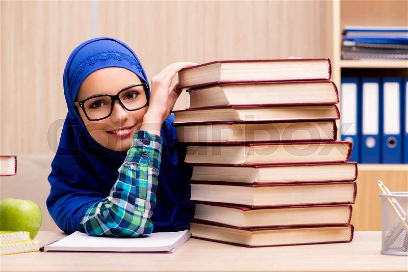 Muslim girl preparing for entry exams, stock photo