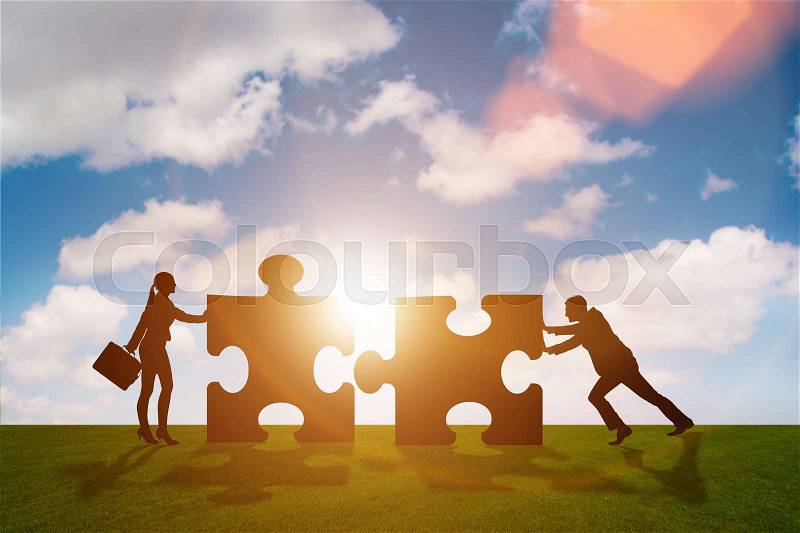 Business metaphor of teamwork with jigsaw puzzle, stock photo