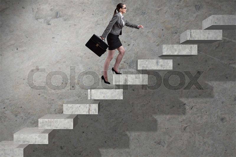 Young businesswoman climbing career ladder, stock photo