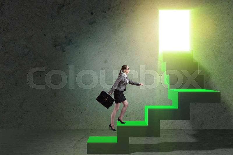 Young businesswoman climbing career ladder, stock photo