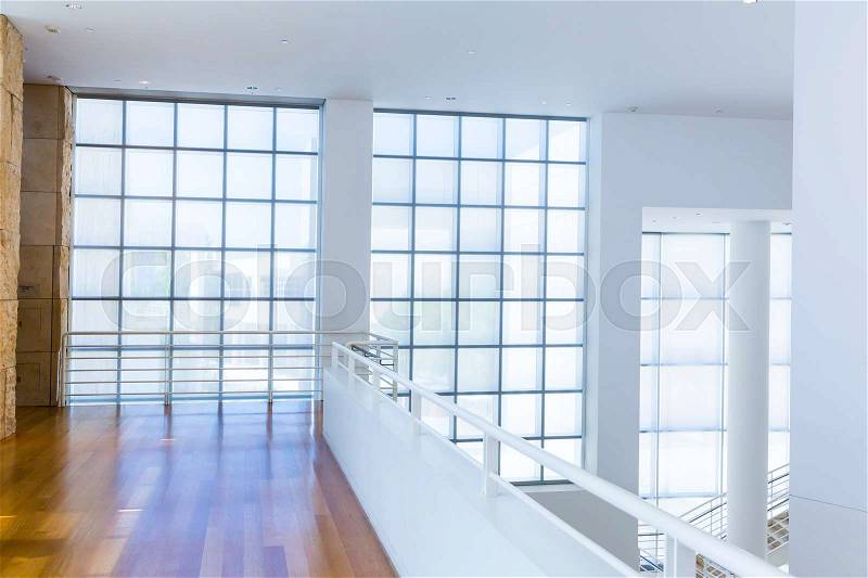 Balcony with wooden floor against glass block wall. White tones style, stock photo