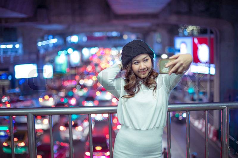 Happy asian woman taking selfie joyful and happy smiling at night, stock photo