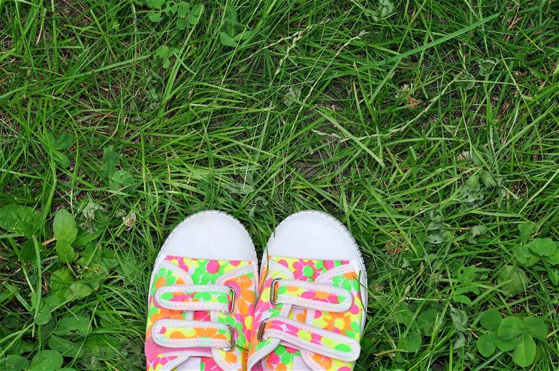 Sports Shoes Sneakers on Fresh Green Grass. Sport in the Open Air. Top View, stock photo
