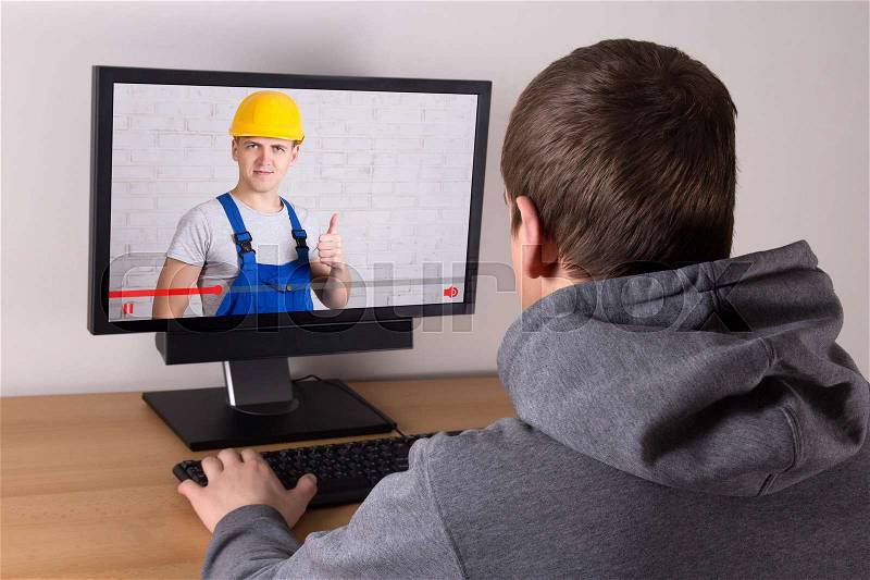 Man watching builder\'s video blog at home, stock photo