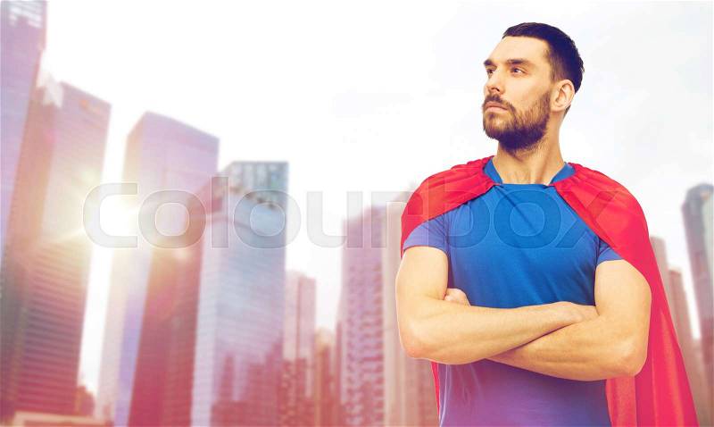 Power and people concept - man in red superhero cape over singapore city skyscrapers background, stock photo