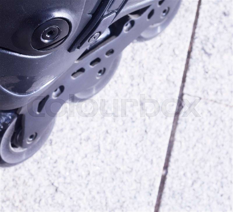 Inline freestyle roller blade skates in street on road surface skating, stock photo
