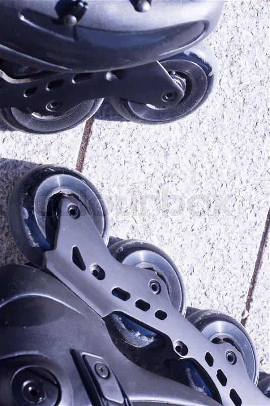 Inline freestyle roller blade skates in street on road surface skating, stock photo