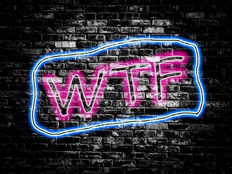 WTF sign on old black vintage brick wall background, stock photo
