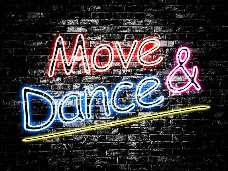 Move and Dance sign on old black vintage brick wall background, stock photo