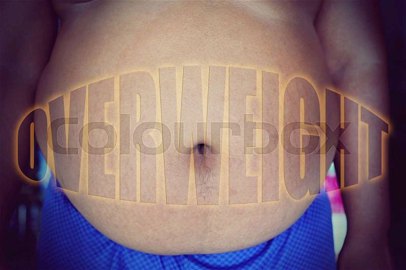 Fat man with a big belly, with word overweight, stock photo