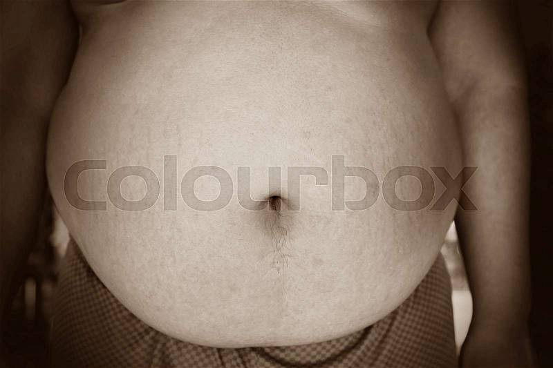 Fat man with a big belly, diet concept, sepia style, stock photo