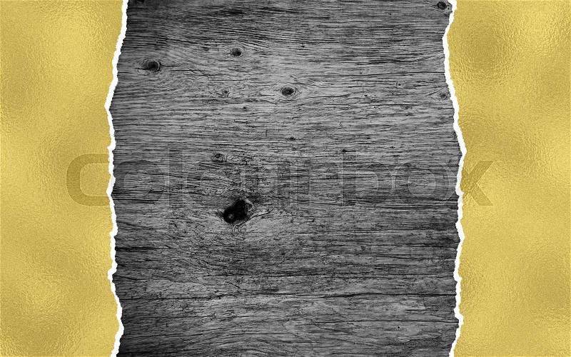 Black wooden background with golden torn paper and copy space, stock photo