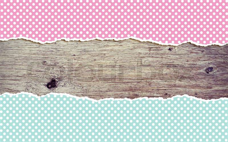 Wooden background with polka dot torn paper and copy space, stock photo