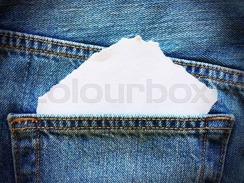 White paper in the pocket of blue denim jeans, stock photo