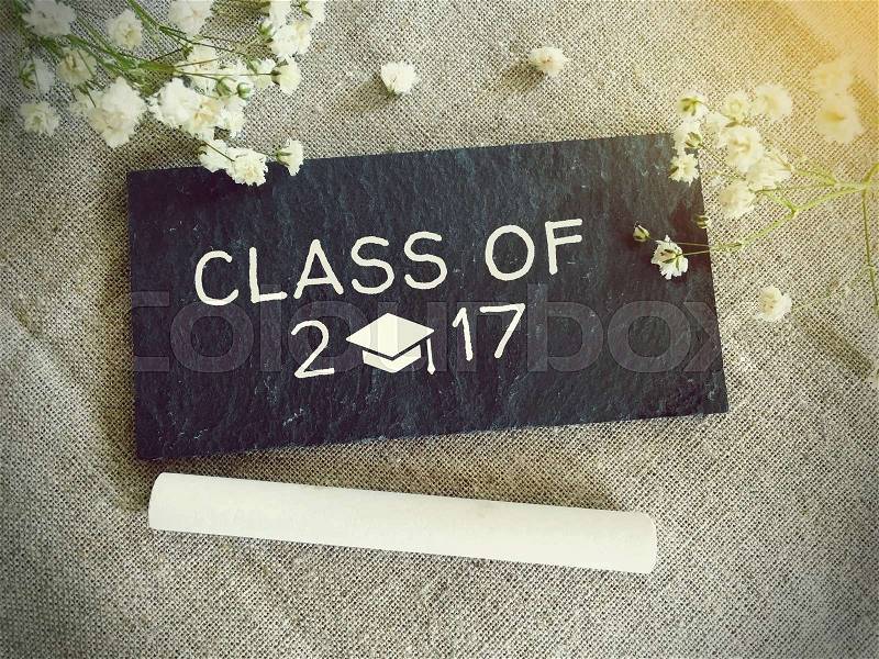 Blackboard for your text and flowers with words class of 2017, stock photo