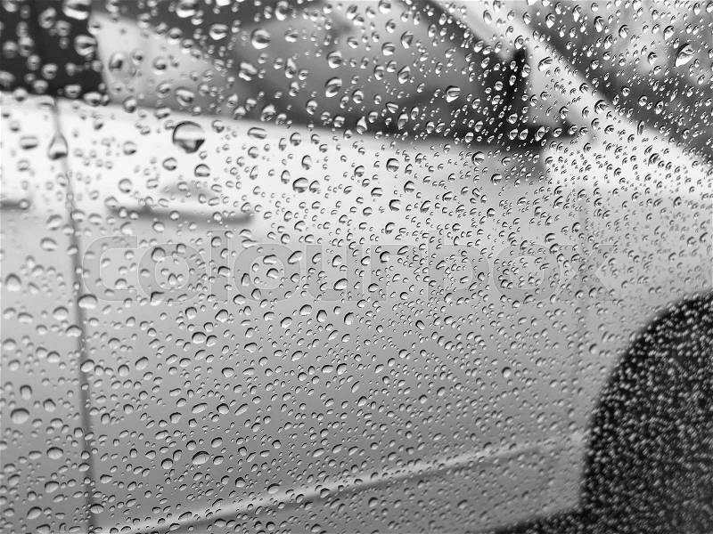 Background with car window after rain in black and white, stock photo