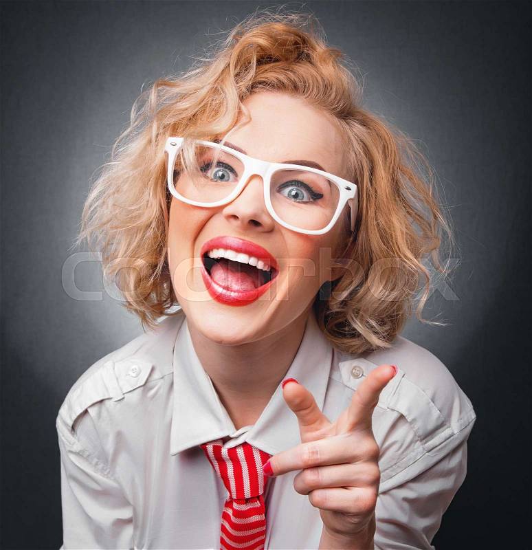 Surprised woman pointing with her finger, close-up funny face, stock photo