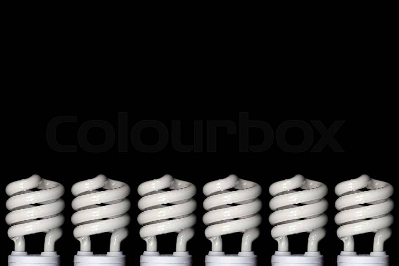 Energy saving fluorescent light bulb on Black background, stock photo