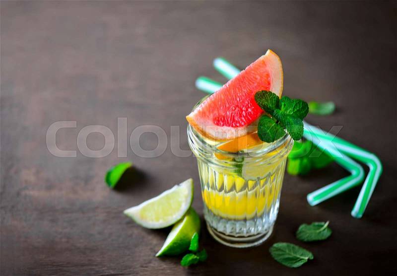 Various citrus infused water in a glass, stock photo