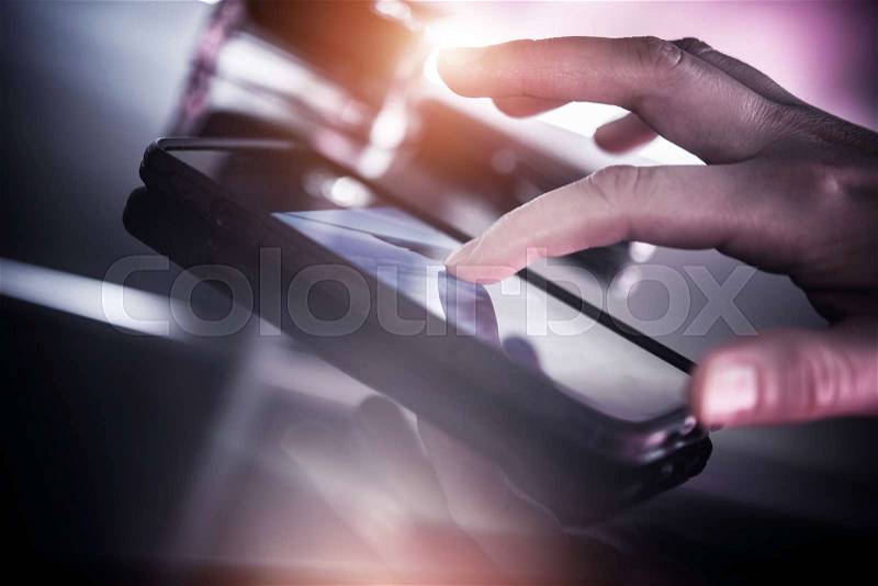 Smartphone Mobile Device. Surfing the Internet on Smartphone. Female Hand Touching the Screen, stock photo