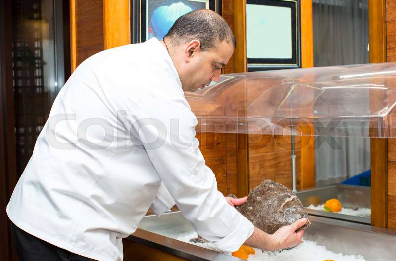Chef of the fish restaurant with seafood lobster crab octopus, stock photo