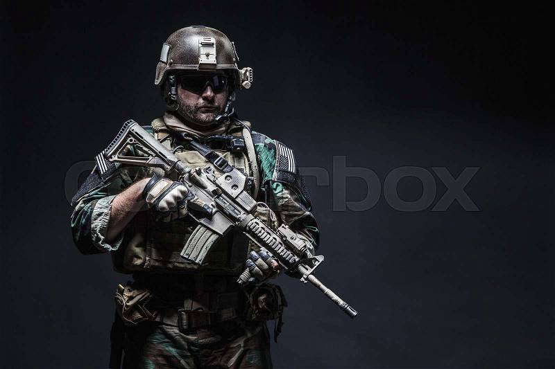 United states Marine Corps special operations command Marsoc raider with weapon. Studio shot of Marine Special Operator black background, stock photo