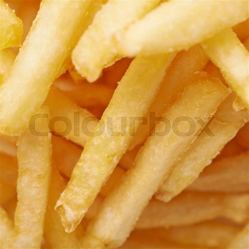 Close-up fragment of a multiple french fries potato chips as a food backdrop composition, stock photo