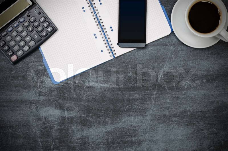 Business desk in office top view. Table with calculator, coffee, notepad, smartphone, and office supplies. Copy space website banner concept, stock photo