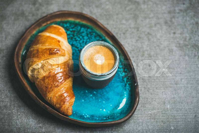 Cup of espresso coffee and croissant in tray, copy space, stock photo