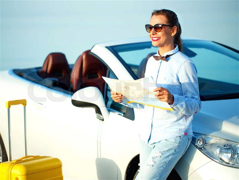 Young pretty woman see the map near the cabriolet - concept summer travel, stock photo