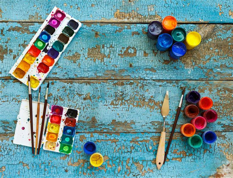 Art of Painting. Painting set: brushes, paints, crayons, watercolor with copyspace on a blue wooden background, stock photo