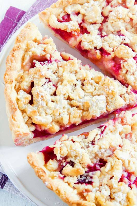 Homemade shortcrust fruit pie with crumble on white background - homemade pastry with fruit or berry (cherry, plum, strawberry, raspberry) jam for tea time, stock photo