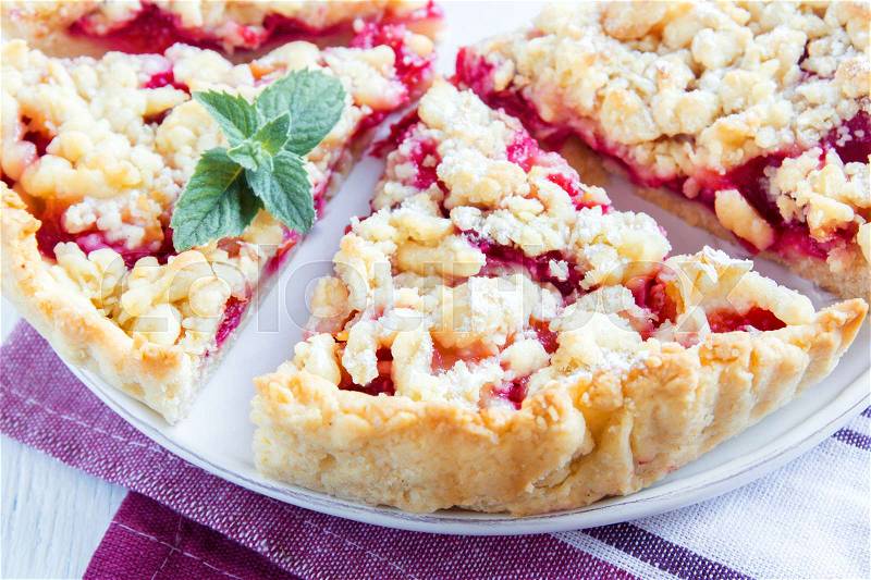 Homemade shortcrust fruit pie with crumble on white background - homemade pastry with fruit or berry (cherry, plum, strawberry, raspberry) jam for tea time, stock photo