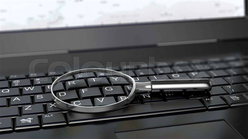 Magnifying glass on laptop computer, stock photo