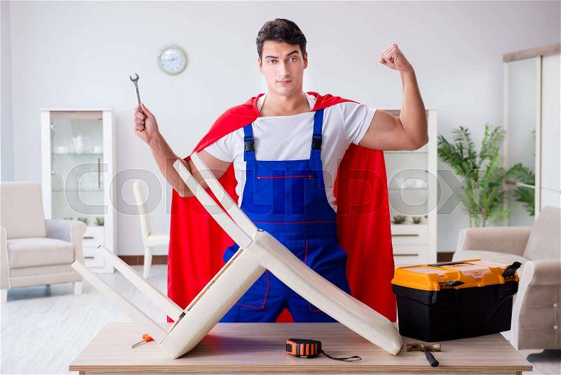 Superhero repairman with tools in repair concept, stock photo