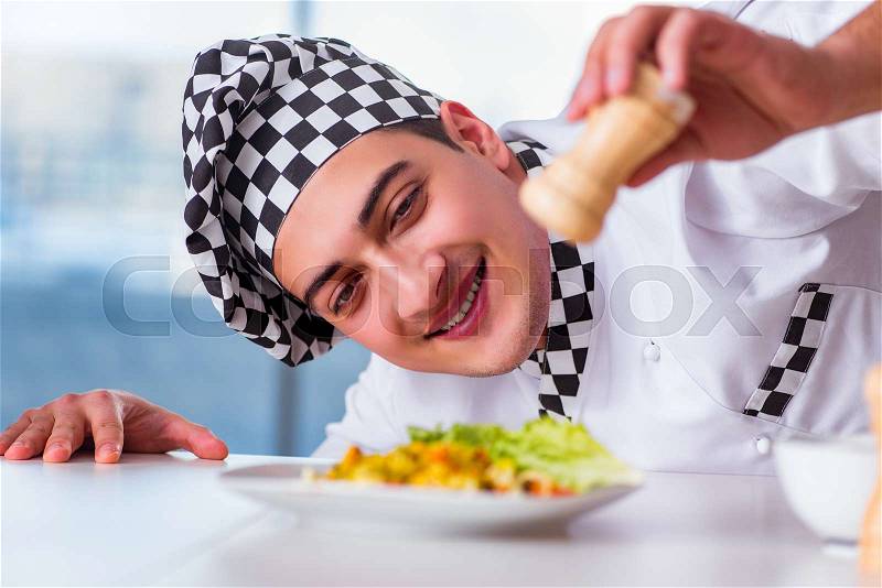 Man preparing food at the kitchen, stock photo