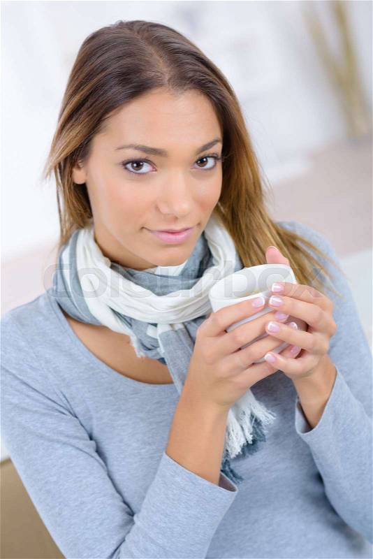 Woman having a coffee at home, stock photo