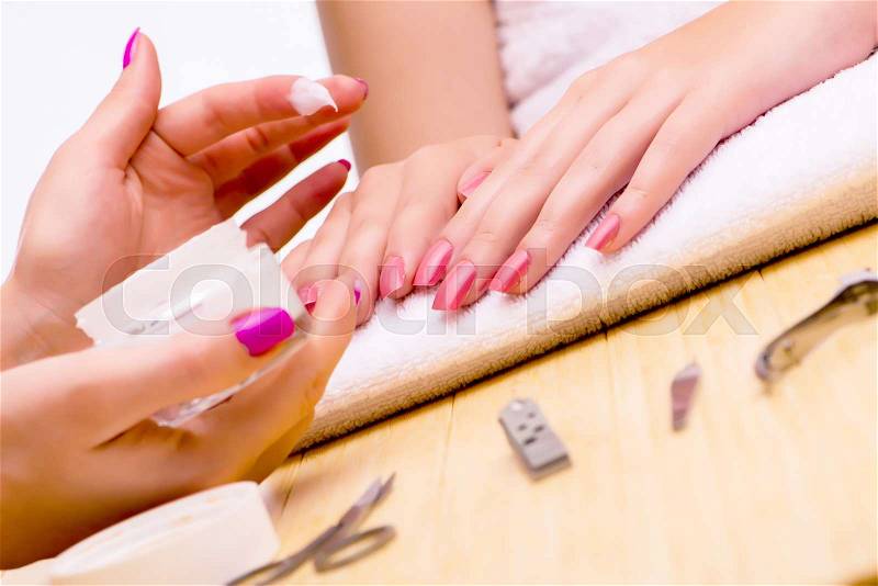 Woman hands during manicure procedure, stock photo